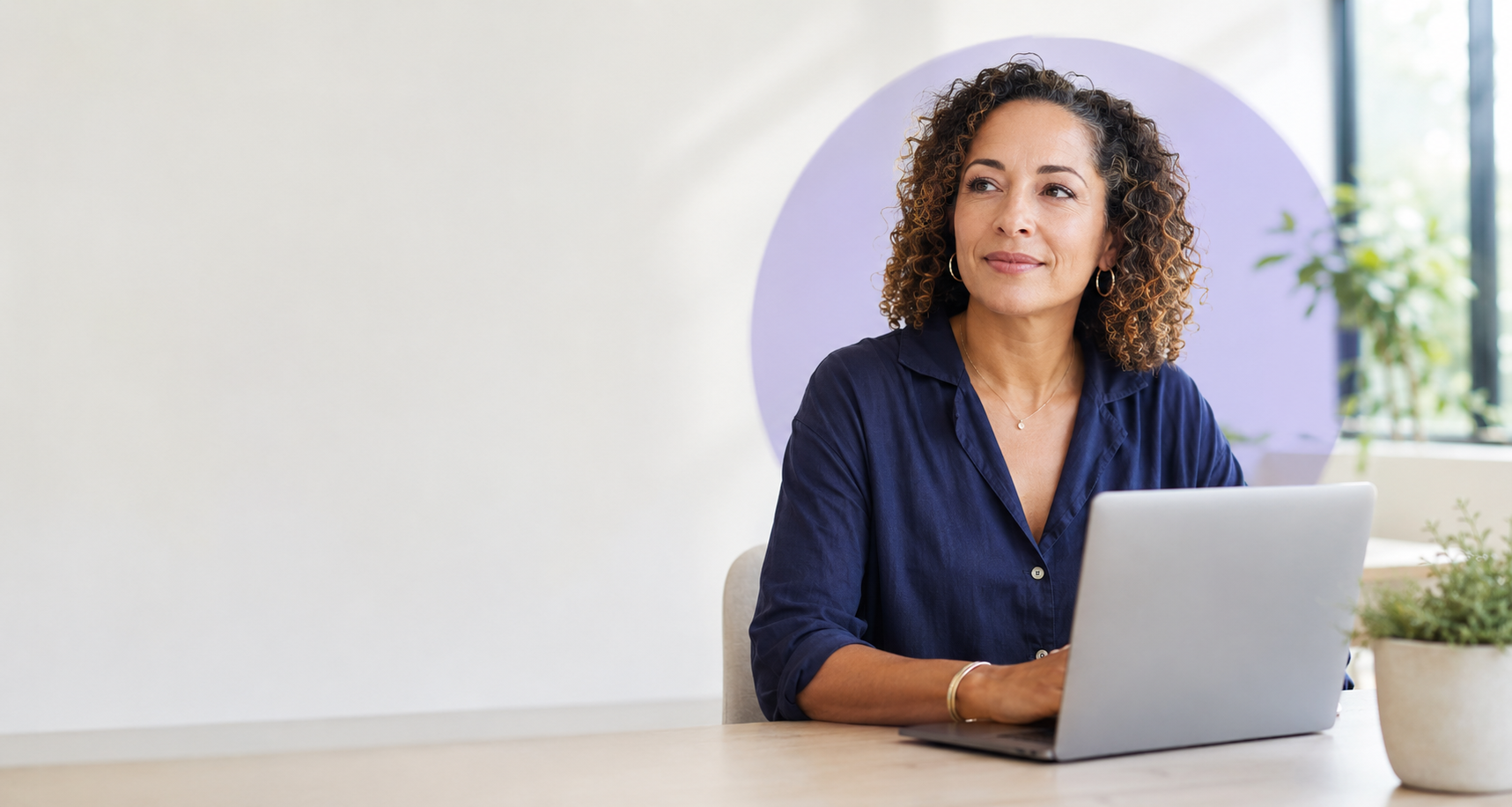 A social work professional using a laptop in a contemporary workspace